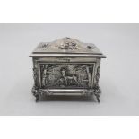 An Edwardian silver jewellery casket and cover, the body chased and engraved with Game vignettes