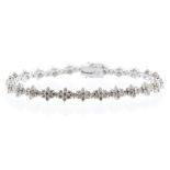 A diamond and 18ct white bracelet, comprising claw set daisy cluster links of small brilliant cut