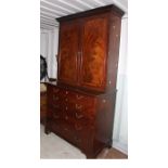 A George III mahogany secretaire bookcase, the upper section with a moulded projecting cornice,