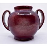 Ruskin Pottery: A Ruskin Pottery sang de boeuf flambe glazed two handled bulbous vase, height approx