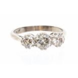 A three stone diamond 18ct gold and platinum ring, comprising three graduated old cut diamonds,