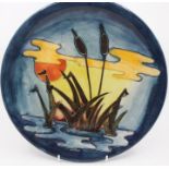 A Moorcroft plate, Reeds at Sunset, by Sally Tuffin, approx 26cm diam, impressed marks to base