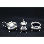 A Georgian style three piece silver condiment set including mustard pot and cover, salt and pepper