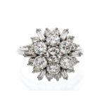 A diamond and 18ct white gold flower cluster ring, comprising round brilliant cut and baguette cut