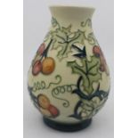A Moorcroft ovoid vase, Holly Berries, cream ground, dated 1996, impressed marks to base, approx