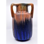Ruskin Pottery: A Ruskin Pottery three handled baluster vase with orange/brown base glaze with