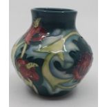 A Moorcroft baluster vase, tubed lined with pink flowers on green ground, impressed marks, dated 95,