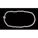 A single strand pearl necklace with diamond and aquamarine platinum clasp, comprising graduated