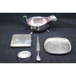 A collection of silver to include: Georgian style silver sauceboat with wavy rim, by Viners,