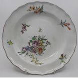 An 18th century Chelsea shaped plate, painted with floral sprays, approx 21.5cm diam, iron red