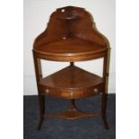 A Geo III mahogany corner washstand with single frieze drawer and shaped up-stand back. Raised on