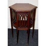 An Edwardian mahogany lamp table, the satinwood crossbanded hexagonal top over pierced panel sides