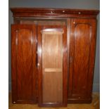 A Victorian mahogany wardrobe press, the moulded cornice over panelled doors enclosing three linen