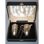 A 1930s Art Deco design silver, presentation cased sugar and cream set with running Celtic band