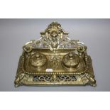 A Victorian cast brass two bottle "rococo" inkstand with pierced detail. 30cm wide