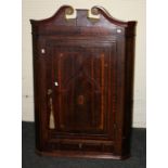 A Geo.III and later oak, mahogany crossbanded and boxwood inlaid wall hanging corner cupboard with