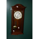A 20th Century Comitti wall clock, the mahogany case enclosing an eight day Westminster Chime