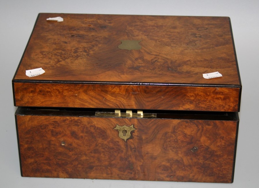 A Victorian walnut writing slope with single well fitted interior. Bears plaque for Parkins and