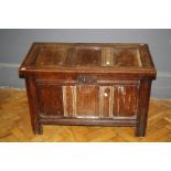 An 18th century oak coffer of small proportions, with three panel top and front on channelled