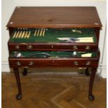 An Edwardian mahogany canteen table containing a twelve place setting of EPNS flatware and cutlery