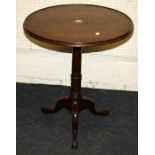 A Geo III mahogany dish-topped circular wine table with girdled gun barrel column over a tripod