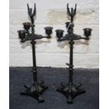 A pair of Louis XV style bronze candlesticks, each with phoenix surmount over three sconces on