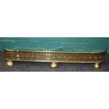 A Geo.III pierced brass fender on half-bun feet. 93 x 15 cms.