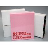 Banksy Captured Volume 2 Pink fabric hardback book in a pink slip case with screenprinted text