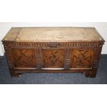 An 18th century oak coffer, the planked top over stop fluted frieze and three geometric parquetry