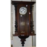 A Vienna style 8 day spring driven wall clock with turned split pilasters.