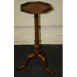 A Geo.II mahogany wine table, the octagonal top on a turned and baluster column, three downswept