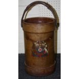 A vintage tan hide cylindrical artillery shell carrier with coat of arms and swing handle 38cm