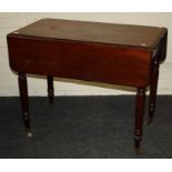 A Victorian mahogany pembroke table, the rectangular top and twin flaps with moulded edge, over