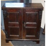 A late 17th/early 18th century oak two cupboard with two moulded panel doors. Raised on shaped