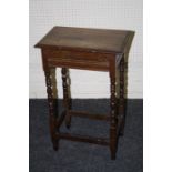 An early 20th century oak stool, the rectangular top on bobbin turned supports united by a box