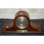 A 1930's walnut and strung Napoleon hat shape mantle clock, the three train movement striking on