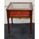 An Edwardian mahogany and strung bijouterie cabinet, the hinged top over red plush lined interior on