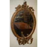 A 19th century giltwood and gesso three branch girondole wall mirror with plain oval plate and