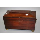 A 19th century mahogany sarcophagus form tea cannister with twin lidded caddy interior and