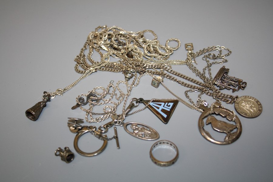 An assortment of silver chains of varying forms some with affixed pendants together with other items