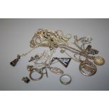 An assortment of silver chains of varying forms some with affixed pendants together with other items