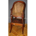 A 19th century mahogany, cane upholstered child's high armchair with detachable sabre leg platform