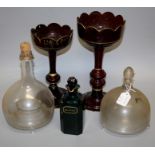 Two Edwardian glass wasp traps, two unmatched ruby glass table lustres (lacking drops) and an