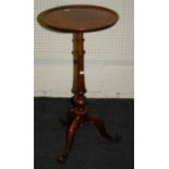 A Victorian walnut dish topped, circular, tripod wine table on a turned segmented column. Raised