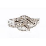 A diamond and 18ct white gold knot ring, comprising alternate rows of small baguette cut and