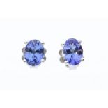 A pair of tanzanite and silver stud earrings, claw set, size approx 6 x 4mm, post and scroll