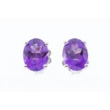 A pair of amethyst and silver stud earrings, claw set, size approx 8 x 6mm, post and scroll fittings