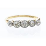 An Edwardian diamond and 18ct gold ring, comprising five graduated old cut diamonds with a total