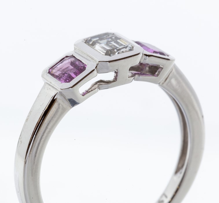 A pink sapphire and diamond three stone 18ct white gold ring, comprising a central emerald cut - Image 2 of 2