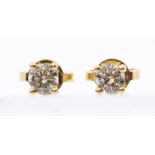 A pair of diamond and 18ct yellow gold stud earrings, the brilliant cut diamonds four claw set,